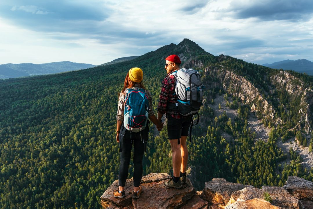 two-tourists-on-the-top-of-the-mountain-a-man-and-a-woman-in-the-mountains.jpg